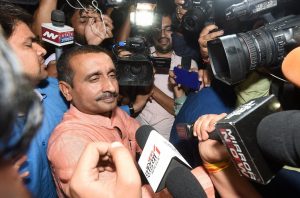 Lucknow: BJP MLA from Unnao Kuldip Singh Sengar, accused in a rape case, surrounded by media persons outside the office of the Senior Superintendent of Police in Lucknow on Wednesday night. PTI Photo by Nand Kumar(PTI4_12_2018_000001B)