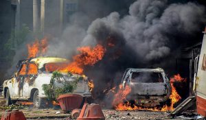 Muzzaffarnagar: Smoke billows out of burning cars during 'Bharat Bandh' against the alleged 'dilution' of Scheduled Castes/Scheduled Tribes act, in Muzzaffarnagar on Monday. PTI Photo (PTI4_2_2018_000236B)