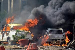 Muzzaffarnagar: Smoke billows out of burning cars during 'Bharat Bandh' against the alleged 'dilution' of Scheduled Castes/Scheduled Tribes act, in Muzzaffarnagar on Monday. PTI Photo (PTI4_2_2018_000236B)