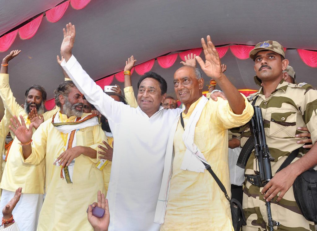 Narsinghpur: Congress leaders Digvijaya Singh and Kamal Nath wave at their party supporters after completion of Singh's six-month-long 'Narmada Parikrama', in Narsinghpur on Monday. PTI Photo (PTI4_9_2018_000176B)