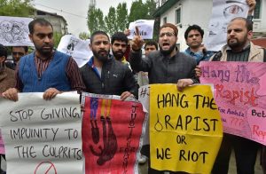 Srinagar: A group of people display placards and raise slogans during a protest demanding justice for eight year old Ashifa of Kathwa Jammu, who was allegedly gangraped and murdered, in Srinagar on Tuesday. PTI Photo by S. Irfan (PTI4_10_2018_000129B)
