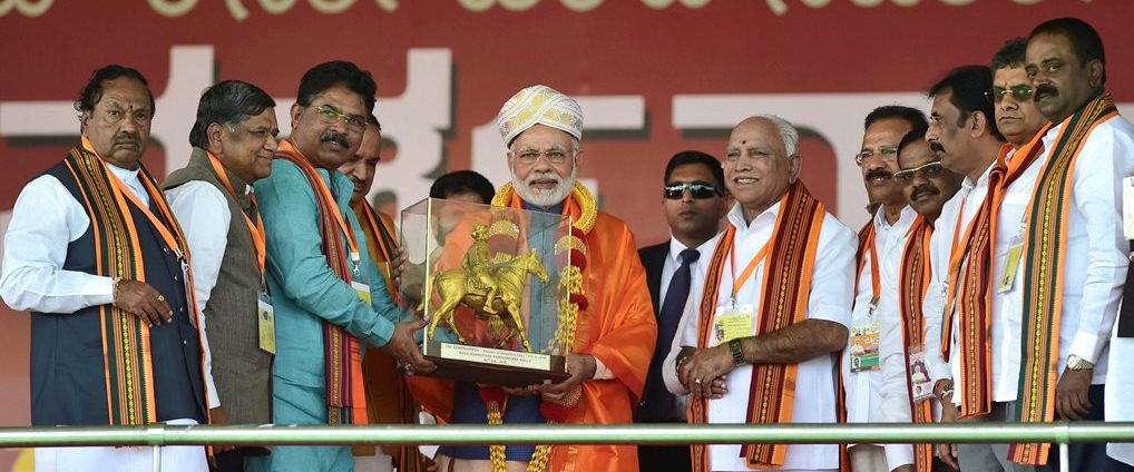 Bengaluru: Prime Minister Narendra Modi being presented a memento by BJP state leaders during the completion of the Parivartan Yatra rally in Bengaluru on Sunday. BJP State Unit President B. S. Yeddyurappa is also seen. PTI Photo by Shailendra Bhojak(PTI2_4_2018_000172B)