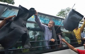 Guwahati: Krishak Mukti Sangram Samiti (KMSS) Advisior Akhil Gogoi waves black flags as he is detained along with supporters in bus, during a protest before the arrival of BJP President Amit Shah at Panjabari in Guwahati on Sunday. PTI Photo (PTI5_20_2018_000056B)