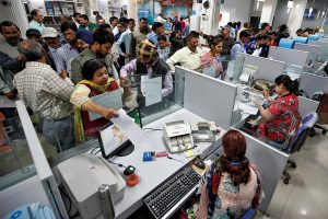 People stand in queues at cash counters to deposit and withdraw money inside a bank in Chandigarh, India, November 10, 2016. Ajay Verma/ REUTERS