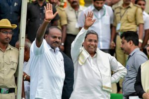 Bengaluru: Newly sworn-in Karnataka Chief Minister H D Kumaraswamy with Karnataka former chief minister & Congress leader Siddaramaiah during the swearing-in ceremony of JD(S)-Congress coalition government, in Bengaluru, on Wednesday. (PTI Photo)(PTI5_23_2018_000160B)
