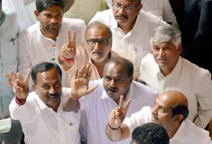 Bengaluru: JD(S) leader HD Kumaraswamy and party MLAs show victory sign to celebrate after chief minister BS Yediyurappa announced his resignation before the floor test, at Vidhana Soudha, in Bengaluru, on Saturday. Supreme Court had ordered Karnataka BJP Government to prove their majority in a floor test at the Assembly .(PTI Photo/Shailendra Bhojak) (PTI5_19_2018_000111B)