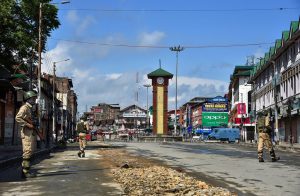 Srinagar: Security personnel stand guard during restrictions and strike called by separatists against Prime Minister Narendra Modi's visit to the state, at Lal Chowk, in Srinagar, on Saturday. (PTI Photo/S Irfan) (PTI5_19_2018_000049B)