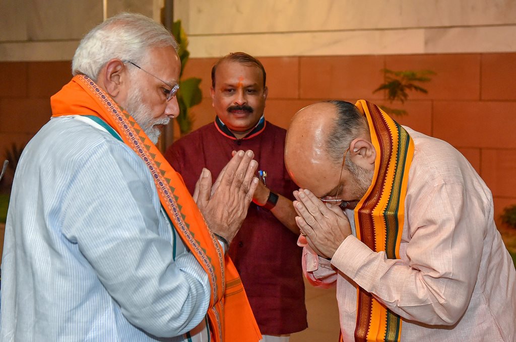 New Delhi: Prime Minister Narendra Modi is greeted by BJP President Amit Shah as he arrives for BJP Parliamentary Board meeting after Karnataka Assembly elections result 2018, in New Delhi, on Tuesday. (PTI Photo/Kamal Kishore) (PTI5_15_2018_000209B)