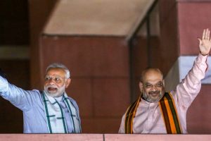 New Delhi: Prime Minister Narendra Modi and BJP President Amit Shah wave to party workers gathered at the party headquarters, after the Karnataka Assembly elections result 2018, in New Delhi, on Tuesday. (PTI Photo) (PTI5_15_2018_000229B)