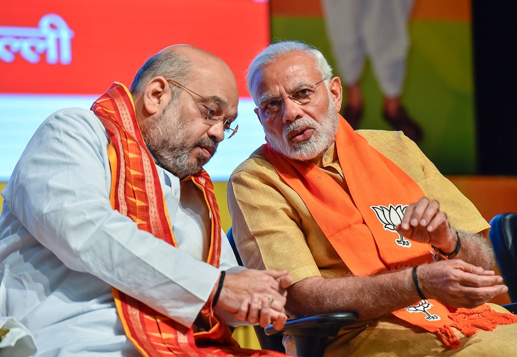 New Delhi: Prime Minister Narendra Modi and BJP National President Amit Shah at the concluding session of the National Executive Committee meeting of the party's all wings (morchas)' at Civic Centre in New Delhi, on Thursday. (PTI Photo/Kamal Singh) (PTI5_17_2018_000164B)