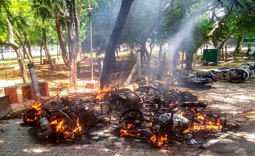 Tuticorin: Smoke billows from burning vehicles after a violent protest demanding closure of Vedanta's Sterlite Copper unit entered the 100th day, in Tuticorin, on Tuesday. The police opened fire in which at least one man was killed. (PTI Photo) (PTI5_22_2018_000137B)