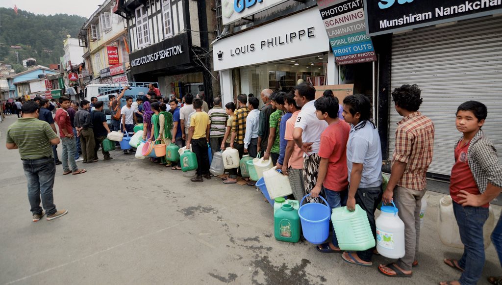 Shimla: People stand in a queue to collect water from a tanker, as the city faces acute shortage of drinking water, at famous MallRoad, in Shimla on Sunday. (PTI Photo)(PTI5_27_2018_000065B)