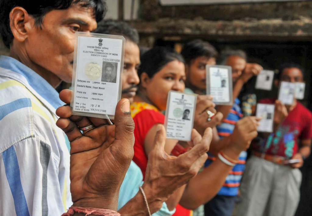 South 24 Parganas: Voters show their Election Commission cards as they queue to cast their vote at a polling station during Maheshtala Assembly by-election, at Maheshtala in South 24 Parganas district of West Bengal, on Monday, 28 May 2018. (PTI Photo)(PTI5_28_2018_000041B)