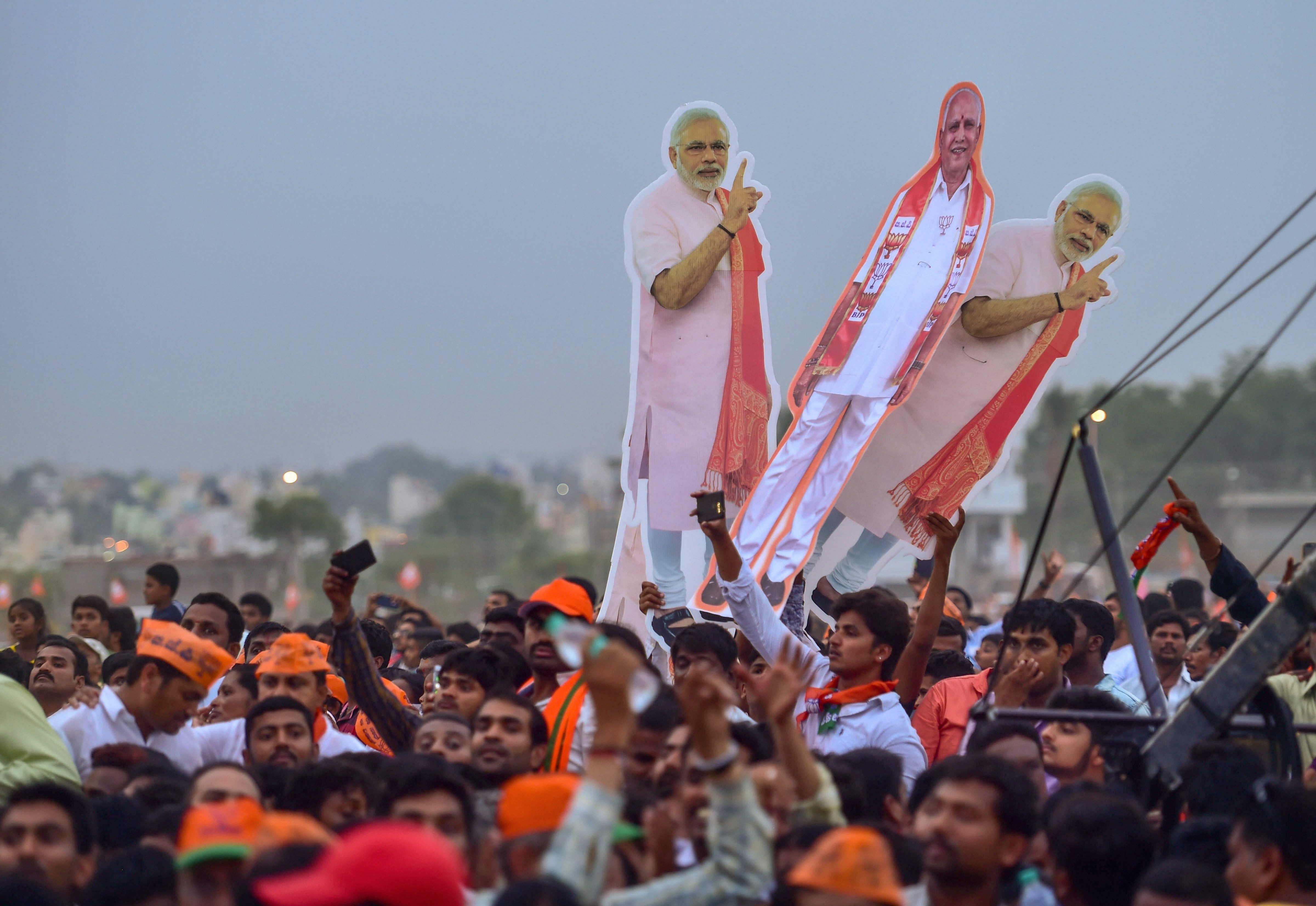 Bengaluru: BJP supporters at Prime Minister Narendra Modi's public rally ahead of Karnataka Assembly elections, in Bengaluru on Thursday. PTI Photo by Shailendra Bhojak (PTI5_3_2018_000193B)