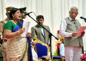 Bengaluru: Karnataka Governor Vajubhai Vala administers the oath to Kannada Veteran actress & Congress MLC Jayamala during the swearing-in ceremony of the new council of ministers of JD(S) and Congress coalition government, at Rajbhavan in Bengaluru on Wednesday, June 06, 2018. (PTI Photo/Shailendra Bhojak) (PTI6_6_2018_000116B)