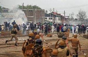 Srinagar: Police and CRPF personnel chase away protesters hurling stones on them during clashes on the outskirts of Srinagar, June 22, 2018. Four militants, a police official and a civilian were killed during gun-battle triggering protests and clashes in which several people were injured. (PTI Photo/ S. Irfan)(PTI6_22_2018_000201B)