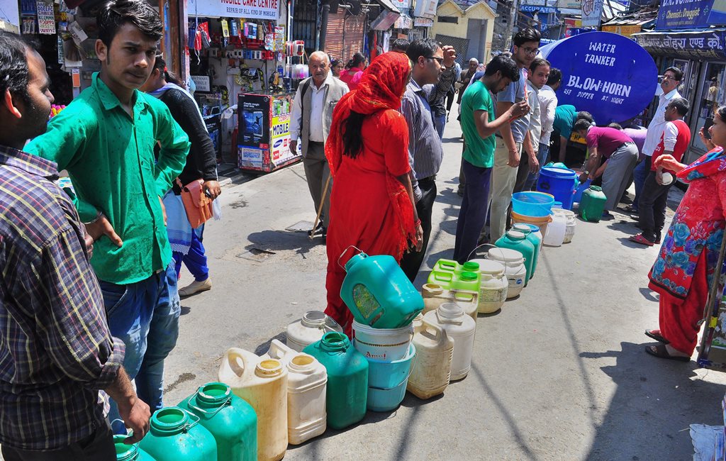 Shimla: People stand in a queue to collect water from a tanker, as the city faces acute shortage of drinking water, in Shimla on Tuesday, May 29, 2018. (PTI Photo) (PTI5_29_2018_000133B)