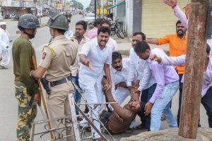 Nanded: A protester is carried away after being injured during a protest rally demanding reservation for Marathis, in Nanded on Tuesday, July 24, 2018. Maratha outfits have called for a bandh in Maharashtra a day after of a protestor demanding reservation for the community jumped off a bridge over Godavari river and died, in Aurangabad. (PTI Photo) (Story no BOM12)(PTI7_24_2018_000217B)