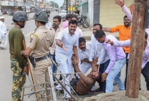 Nanded: A protester is carried away after being injured during a protest rally demanding reservation for Marathis, in Nanded on Tuesday, July 24, 2018. Maratha outfits have called for a bandh in Maharashtra a day after of a protestor demanding reservation for the community jumped off a bridge over Godavari river and died, in Aurangabad. (PTI Photo) (Story no BOM12)(PTI7_24_2018_000217B)
