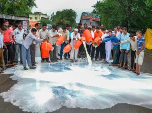 Ahmednagar: Swabhimani Shetkari Sanghatna activists during a demonstration demanding a subsidy of Rs 5 per litre milk, waiver of goods and services tax on butter and milk powder among others, at Shiradhon Village in Ahmednagar on Monday, July 16, 2018. (PTI Photo) (PTI7_16_2018_000176B)