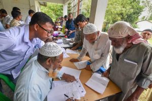 Nagaon: People check their names on the final draft of the state's National Register of Citizens after it was released, at a NRC Seva Kendra in Nagaon on Monday, July 30, 2018. (PTI Photo) (PTI7_30_2018_000108B)