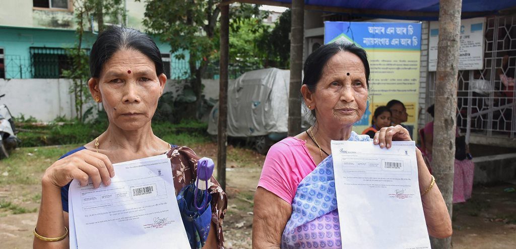 Guwahati: Maya Devi Sonar (left) and Malati Thapa, residents of Hatigaon, show documents outside the National Register of Citizens (NRC) Seva Kendra claiming that their and their family members’ names were not included in the final draft of the state's NRC, in Guwahati on Monday, July 30, 2018. (PTI Photo) (PTI7_30_2018_000117B)
