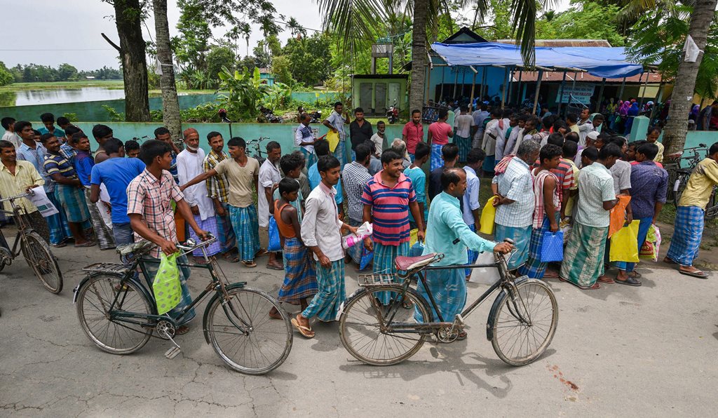 Nagaon: People wait to check their names on the final draft of the state's National Register of Citizens after it was released, at a NRC Seva Kendra in Nagaon on Monday, July 30, 2018. (PTI Photo) (PTI7_30_2018_000126B)