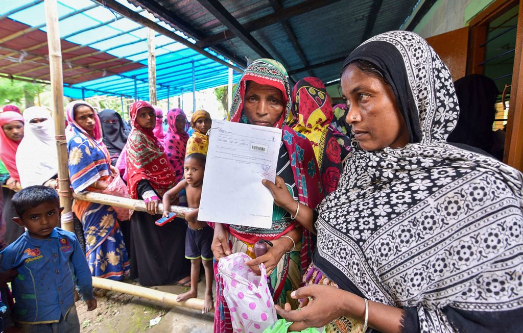 Nagaon: People wait to check their names on the final draft of the state's National Register of Citizens after it was released, at an NRC Seva Kendra in Nagaon on Monday, July 30, 2018. (PTI Photo) (PTI7_30_2018_000127B)