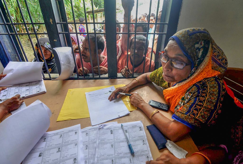 Morigaon: People wait in a queue to check their names on the final draft of the state's National Register of Citizens after it was released, at an NRC Seva Kendra, in Morigaon on Monday, July 30, 2018. (PTI Photo) (PTI7_31_2018_000037B)