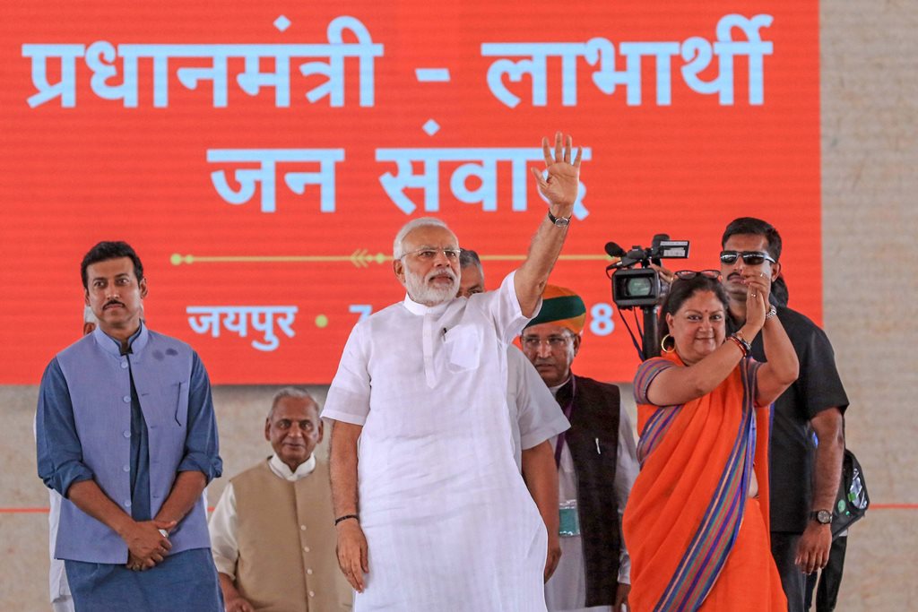 Jaipur: Prime Minister Narendra Modi waves to the beneficiaries of various welfare schemes of the BJP government, at a meeting in Jaipur on Saturday, July 7, 2018. Rajasthan Chief Minister Vasundhara Raje and Union minister Rajyavardhan Singh Rathore are also seen. (PTI Photo) (PTI7_7_2018_000092B)
