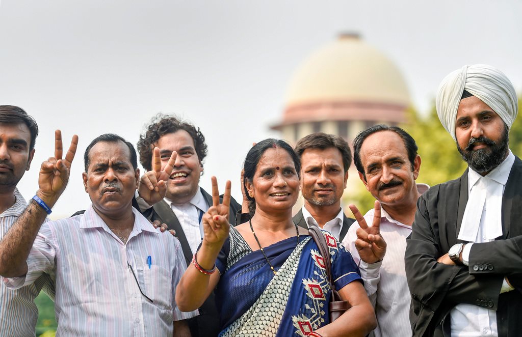 New Delhi: Nirbhaya's parents show victory sign after the Supreme Court's verdict on Dec 2012 gang rape case, in New Delhi on Monday, July 9, 2018. The apex court upheld the death sentence of the three convicts in the case. (PTI Photo/Ravi Choudhary) (PTI7_9_2018_000076B)