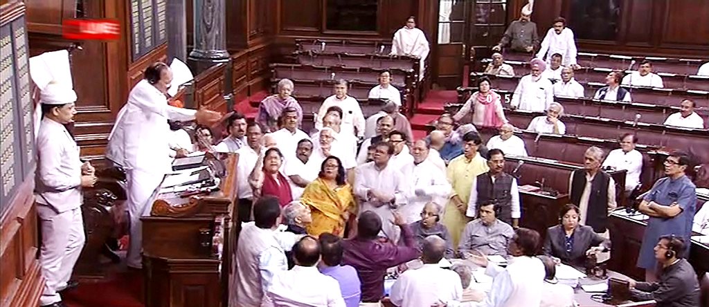 New Delhi: Rajya Sabha Chairman M Venkaiah Naidu tries to pacify the opposition members who were protesting in the well of the Houyse, during the Monsoon session of Parliament, in New Delhi on Tuesday, July 31, 2018. (RSTV GRAB via PTI) (PTI7_31_2018_000089B)