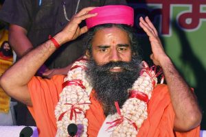 Patna: Swami Ramdev after being offered a 'Makhana-garland' during a function, in Patna on Monday, July 16, 2018. (PTI Photo) (PTI7_16_2018_000021B)