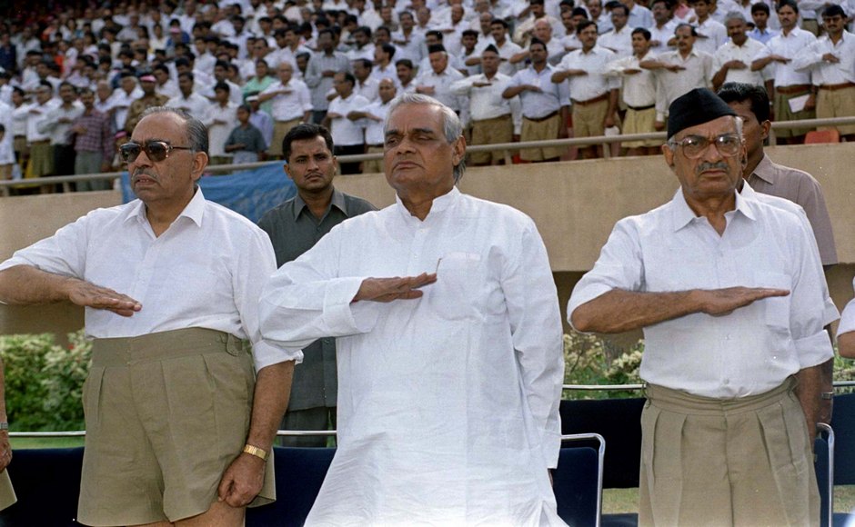 Atal Behari Vajpayee (C), prime ministerial candidate of India's Hindu nationalist Bharatiya Janata Party (BJP) salutes with his members at a Rashtriya Swayamsevak Sangh (National Volunteers Organisation) rally in New Delhi. The RSS is a secretive organisation devoted to to remoulding Indian society into a Hindu nation. Picture taken 2OCT97. 