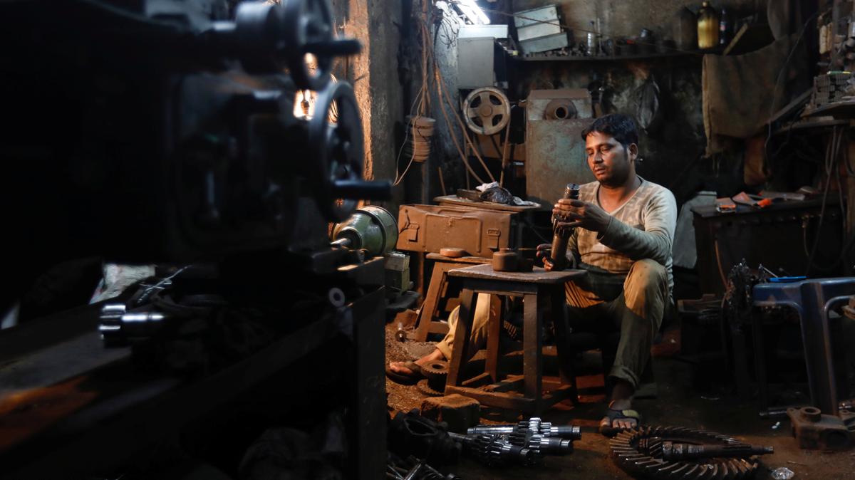 A man repairs gear parts used in automobiles inside a workshop at an industrial area in Mumbai, India. Small businesses have been struggling with the new tax. (Photo: Danish Siddiqui/Reuters)