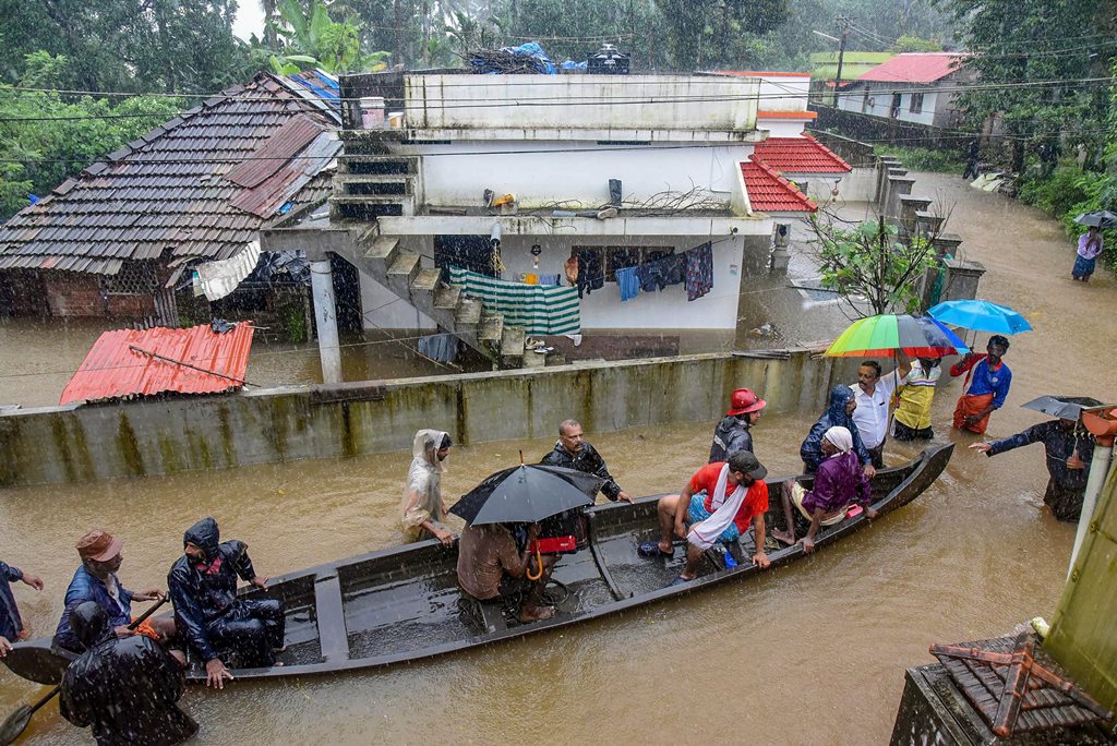 Kochi: Rescue officials assist villagers out of a flooded area following heavy monsoon rainfall, near Kochi on Wednesday, Aug 15, 2018. (PTI Photo) (PTI8_15_2018_000266B)
