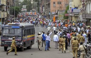Solapur: Police personnel clash with the Maratha Kranti Morcha protesters during their district bandh called for reservations in jobs and education, in Solapur, Maharashtra on Monday, July 30, 2018. (PTI Photo) (PTI7_30_2018_000215B)