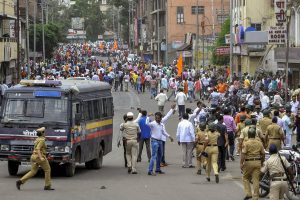 Solapur: Police personnel clash with the Maratha Kranti Morcha protesters during their district bandh called for reservations in jobs and education, in Solapur, Maharashtra on Monday, July 30, 2018. (PTI Photo) (PTI7_30_2018_000215B)