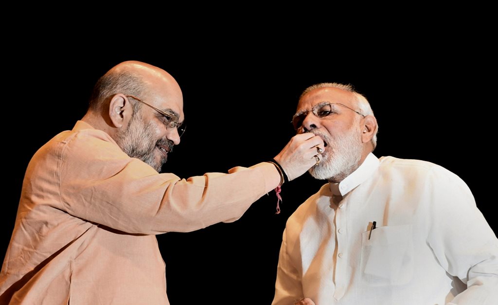 New Delhi: Prime Minister Narendra Modi being offered sweets by BJP President Amit Shah during BJP Parliamentary Party meeting, in New Delhi on Tuesday, July 31, 2018. (PTI Photo/Atul Yadav) (PTI7_31_2018_000030B)