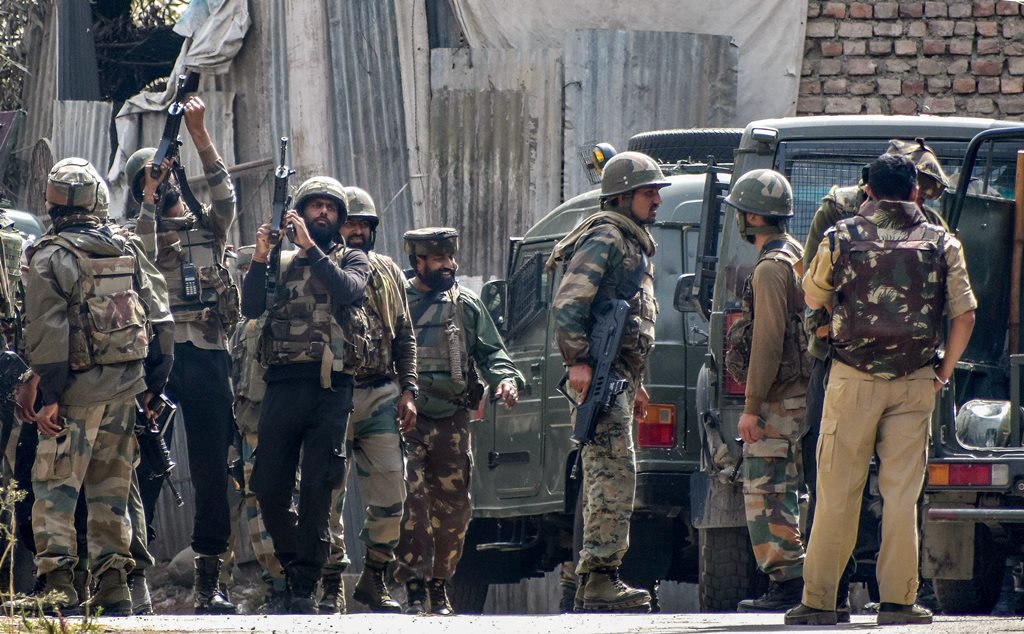 Budgam: Security forces position themselves near the mosque where militants were hiding during an encounter, at Panzan Chadoora area of Budgam district near Srinagar, Thursday, Sept 27, 2018. Five persons, including three militants, were killed in three separate incidents. (PTI Photo) (PTI9_27_2018_000153B)