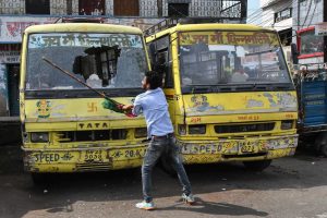 Patna: Jan Adhikar Party supporter vandalises vehicles during 'Bharat Bandh' protest against fuel price hike and depreciation of the rupee, in Patna, Monday, Sept 10, 2018. (PTI Photo)(PTI9_10_2018_000026B)