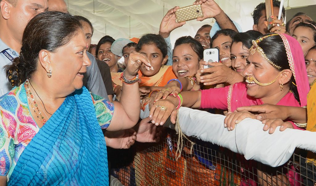 Barmer: Rajasthan Chief Minister Vasundhara Raje interacts with women in a public rally during her 'Rajasthan Gaurav Yatra' at Gudamalani, near Barmer on Saturday, Sept 1, 2018. (PTI Photo) (PTI9_1_2018_000109B)