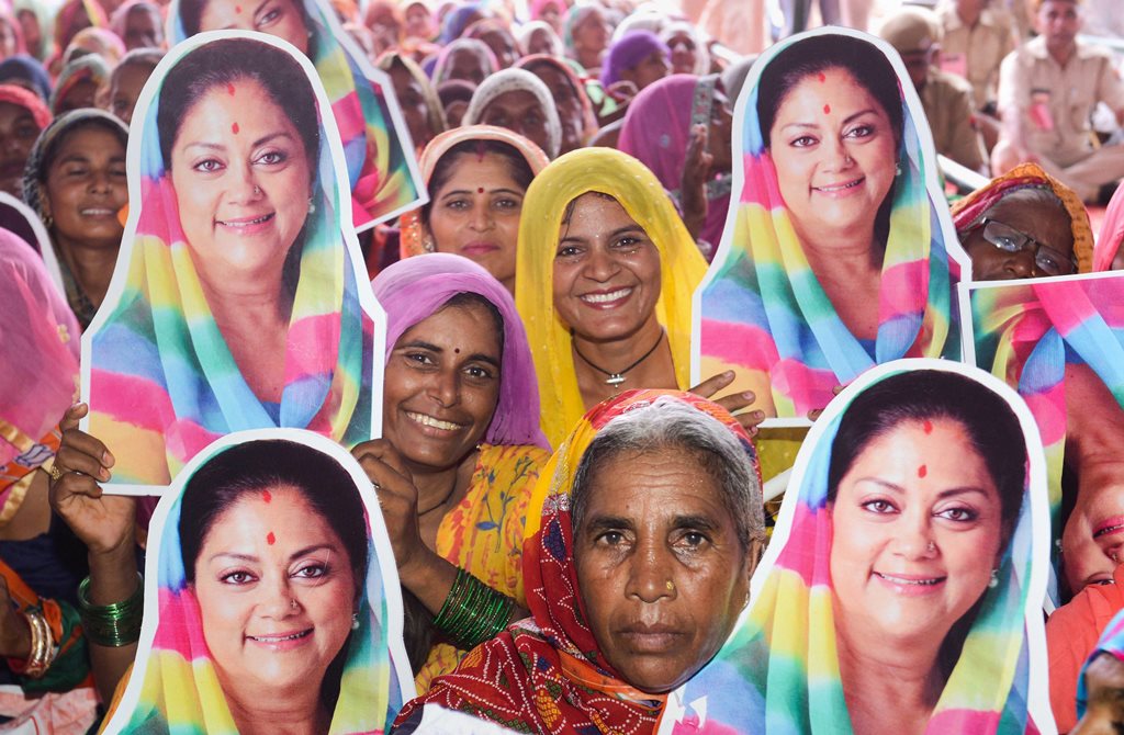 Sriganganagar: Women hold posters of Rajasthan Chief Minister Vasundhara Raje during the party's 'Rajasthan Gaurav Yatra', in Sriganganagar, Saturday, Sept 8, 2018. (PTI Photo) (PTI9_8_2018_000051B)