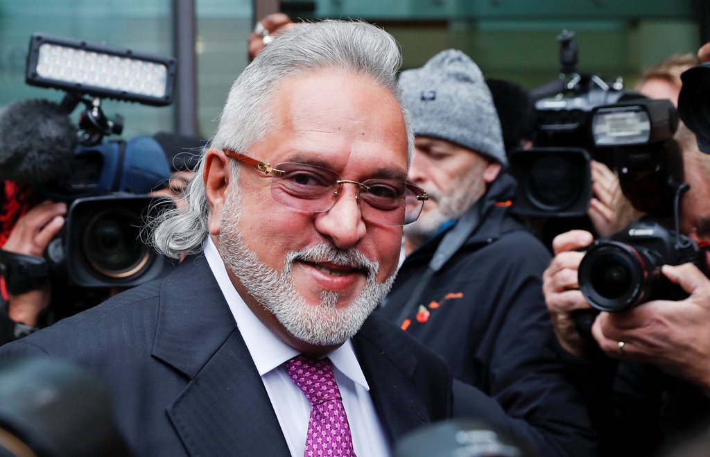 London: F1 Force India team boss Vijay Mallya smiles as he arrives to attend a hearing at Westminster Magistrates Court in London, Wednesday, Sept. 12, 2018. Investigators have accused the 62-year-old of paying $200,000 to a British firm for displaying his company Kingfisher's logo during the Formula One World Championships in London and some European countries in the 1990s. AP/PTI(AP9_12_2018_000201B)