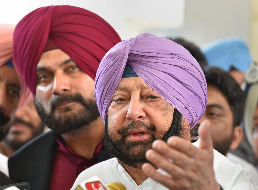 Amritsar: Punjab Chief Minister Capt Amrinder Singh with Punjab Minister Navjot Singh Sidhu talk to the media after visiting Guru Nanak Hospital, in Amritsar, Saturday, Oct 20, 2018. A speeding train ran over revellers watching fireworks during the Dussehra festival Friday, killing at least 60 people. (PTI Photo/Kamal Kishore)(PTI10_20_2018_000096B)