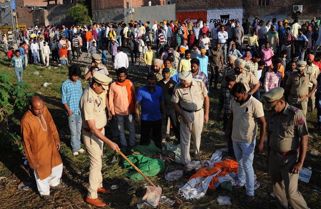 Amritsar: Punjab Police personnel at the scene of the accident along railroad tracks in Amritsar on October 20, 2018, after revellers who gathered on the tracks were killed by a moving train on October 19. - A speeding train ran over revellers watching fireworks during a Hindu festival in northern India Friday, killing more than 50 people, with eyewitnesses saying they were given no warning before disaster struck.(PTI Photo)(PTI10_20_2018_000004)