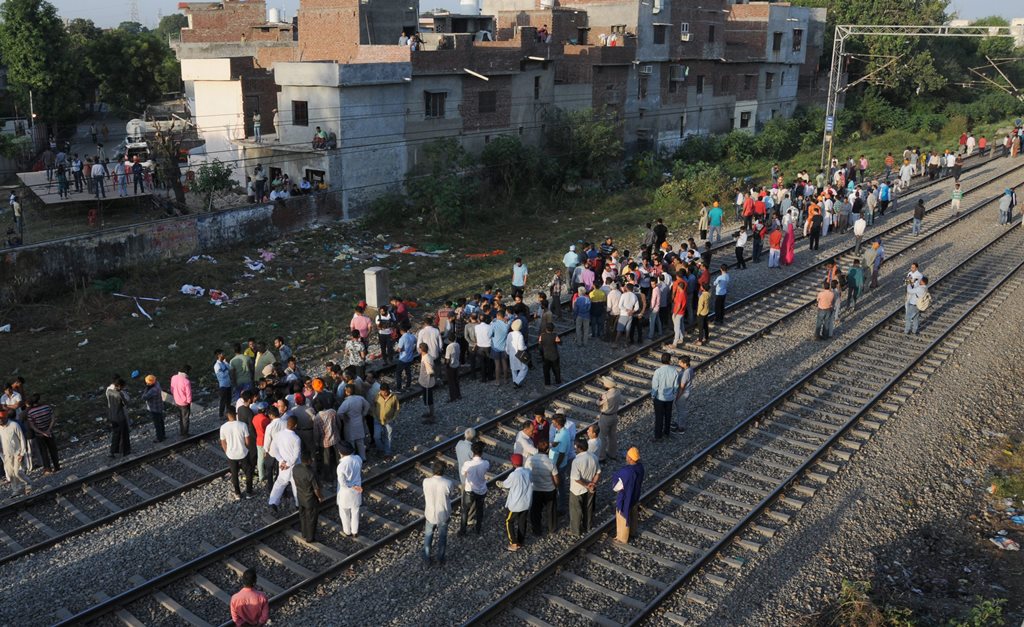 Amritsar: Punjab Police personnel and local people gather at the scene of the accident along train tracks in Amritsar, Saturday, October 20, 2018. A speeding train ran over revellers watching fireworks during the Dussehra festival Friday, killing more than 50 people. (PTI Photo) (PTI10_20_2018_000007B)