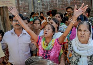 Amritsar: Relatives of victims of train accident mourn at Mass funeral in Amritsar, Saturday, Oct 20, 2018. Officials said at least 60 bodies have been found and many more injured have been admitted to a government hospital after the accident near the site of Dussehra festivities. (PTI Photo) (PTI10_20_2018_000061)