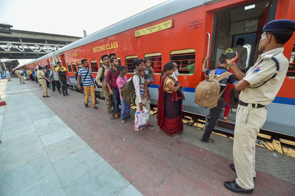 Ahmedabad: Migrant workers wait to board a train out of Gujarat in view of protests and violence breaking out over the alleged rape of a 14-month-old girl, in Ahmedabad, Tuesday, Oct 9, 2018. (PTI Photo/Santosh Hirlekar) (PTI10_9_2018_000084B)