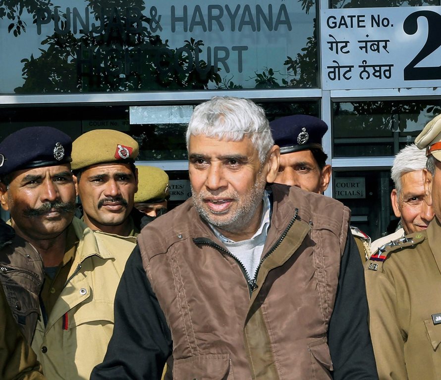 **FILE** Chandigarh: In this file photo dated Dec 23, 2014, is seen self-proclaimed godman Rampal being produced in Punjab & Haryana High Court in Chandigarh. Rampal and 27 of his followers on Thursday, Oct 11, 2018, were charged with murder and wrongful confinement after four women and a child were found dead in his Satlok Ashram in Barwala town in Hisar on November 19, 2014. (PTI Photo) (PTI10_11_2018_000067B)